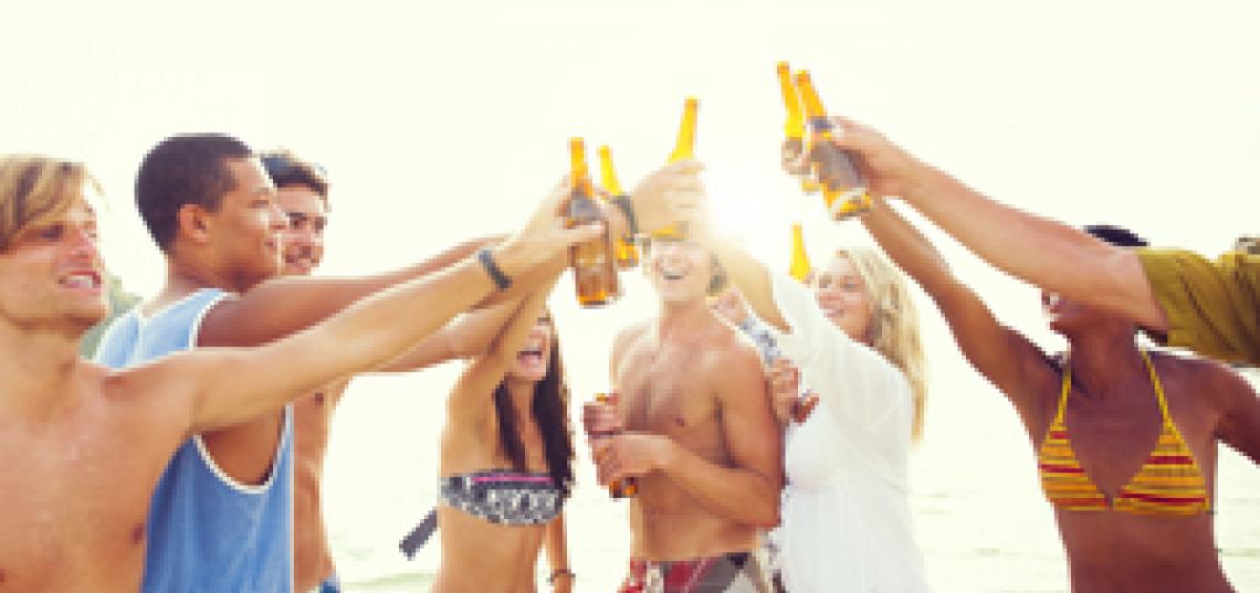 students at the beach drinking 