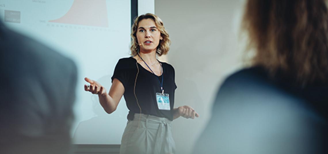 Women in short black shirt addressing a group The Professional Health Communication Certificate